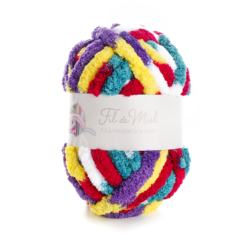 pelote de fil multicolore tissage torsadé, label “Fil de Miel” sur étiquette blanche, couleurs violet, jaune, rouge, bleu et blanc.